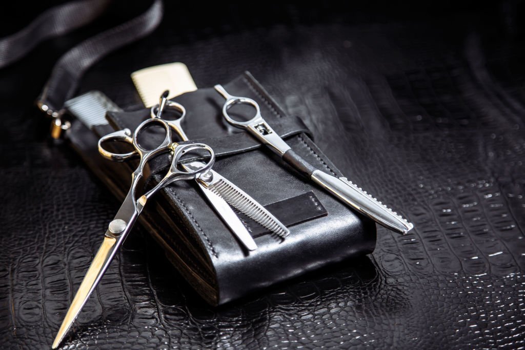 Professional tools of hairdresser in black leather case